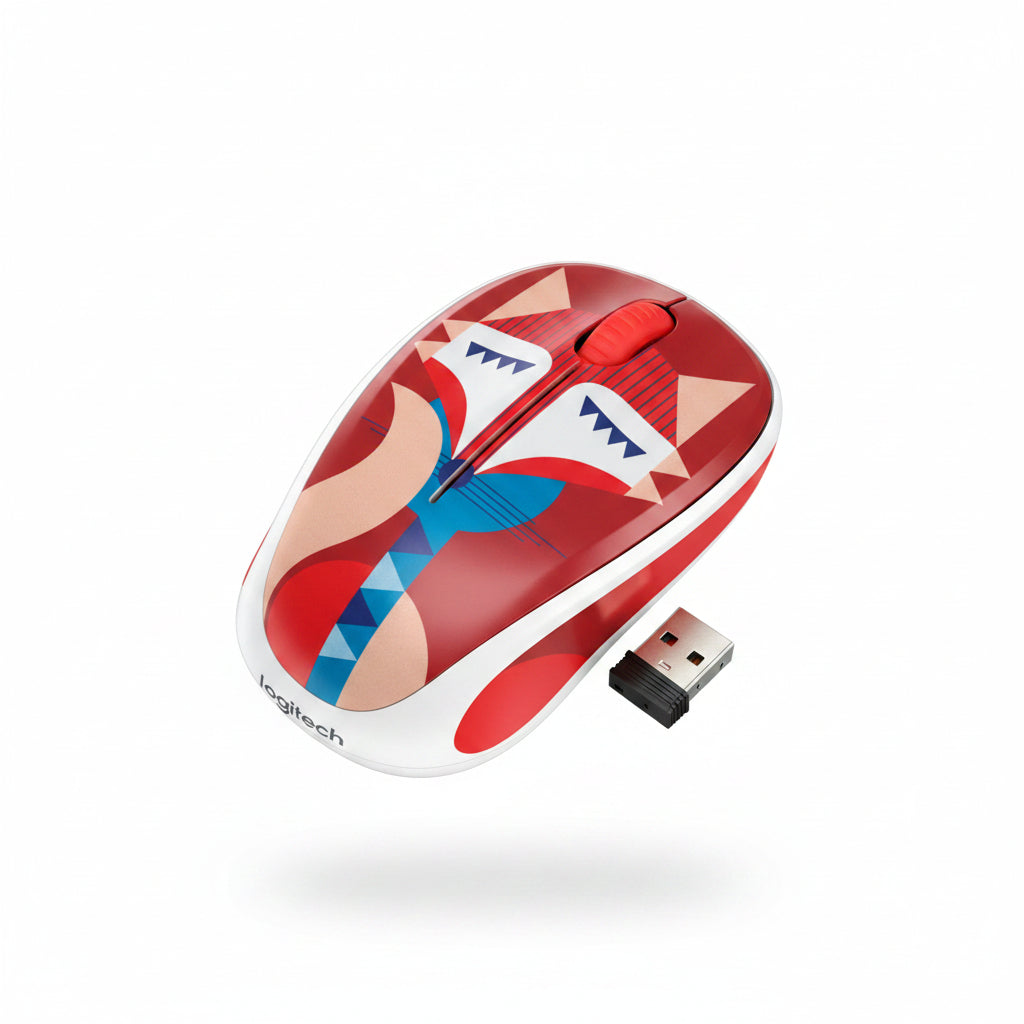 A computer mouse with a colorful geometric fox pattern in red, blue, beige, and white, still inside a clear plastic protective wrapper, placed on a dark wood-grain surface.